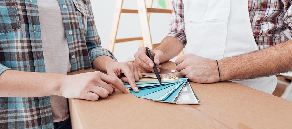 A contractor walks a homeowner through his options for colors for kitchen remodeling