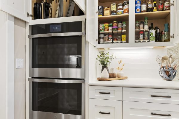 white kitchen with custom cabinets and vertical pan storage Margaritaville, SC new construction